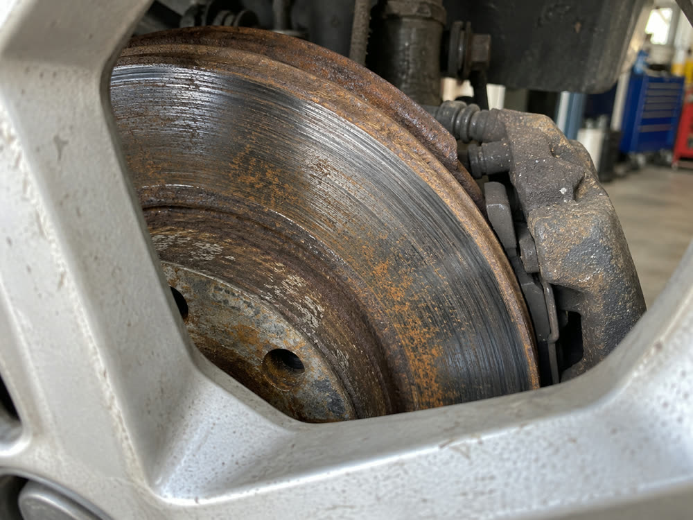 The worn brake disc and pad, before the work