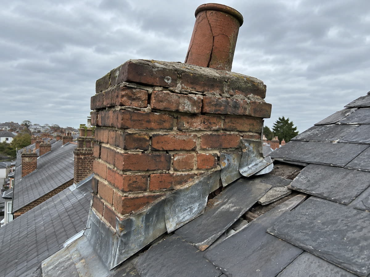 Before: a chimney with crumbling mortar and split lead flashing
